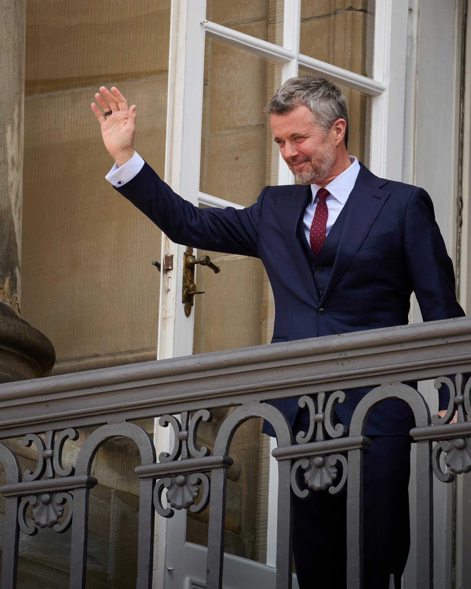 King Frederik X of Denmark steps onto the balcony of Amalienborg Castle to greet the crowd.